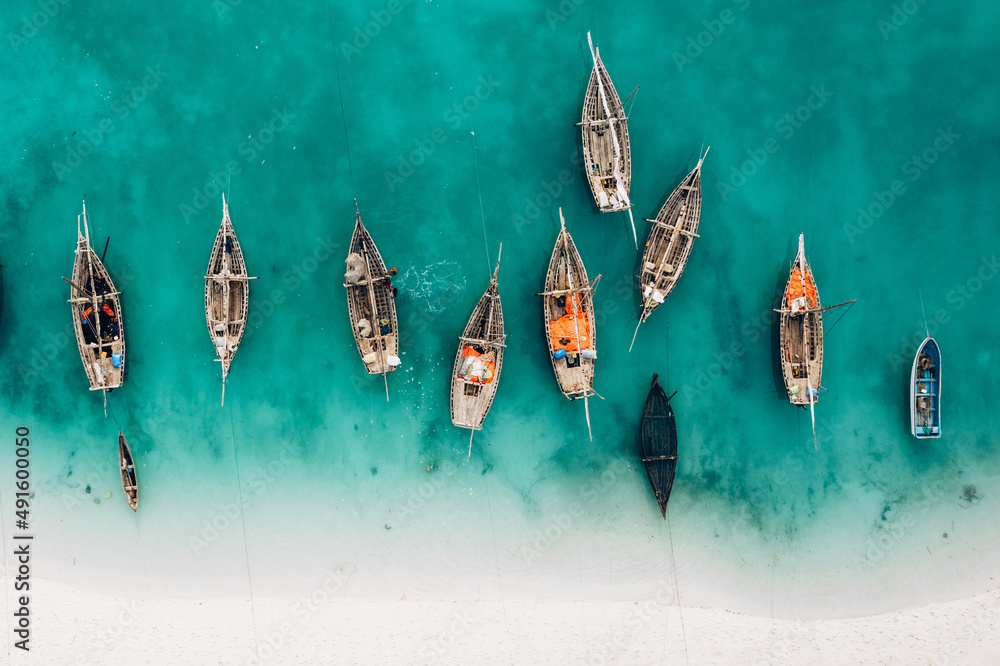 Top view or aerial view of Beautiful crystal clear water and white beach with long tail boats in summer of Zanzibar island